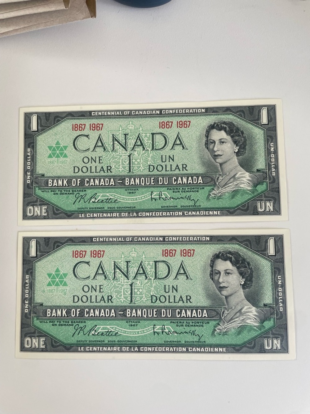 1967 set of 2 - Canada Centennial One Dollar Bills - Green - uncirculated